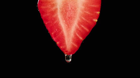 close-up of a strawberry slice with water droplet