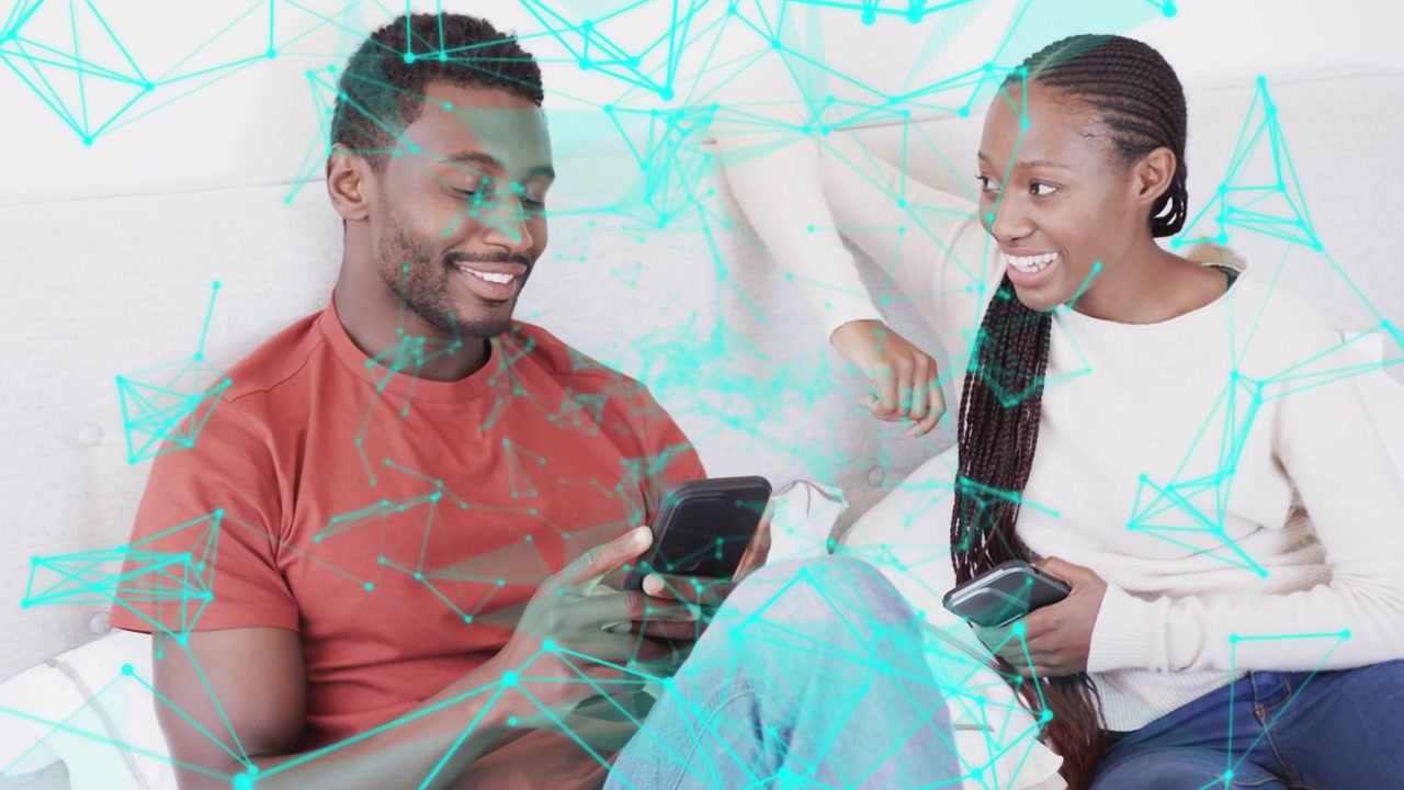 Vertical video: Tapping phone man red tee sharing info with woman with device on sofa turquoise net