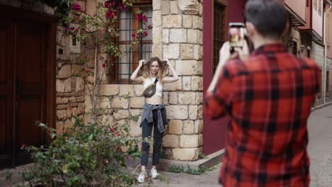 young couple tourists on a summer trip taking pictures using mobile