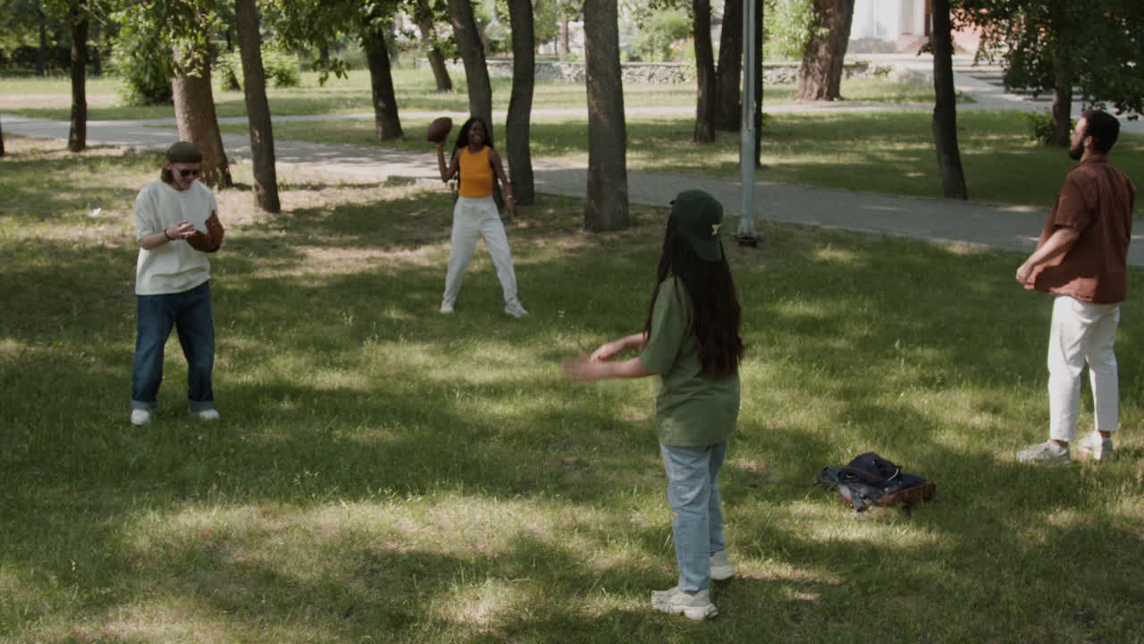 Friends playing football in a park