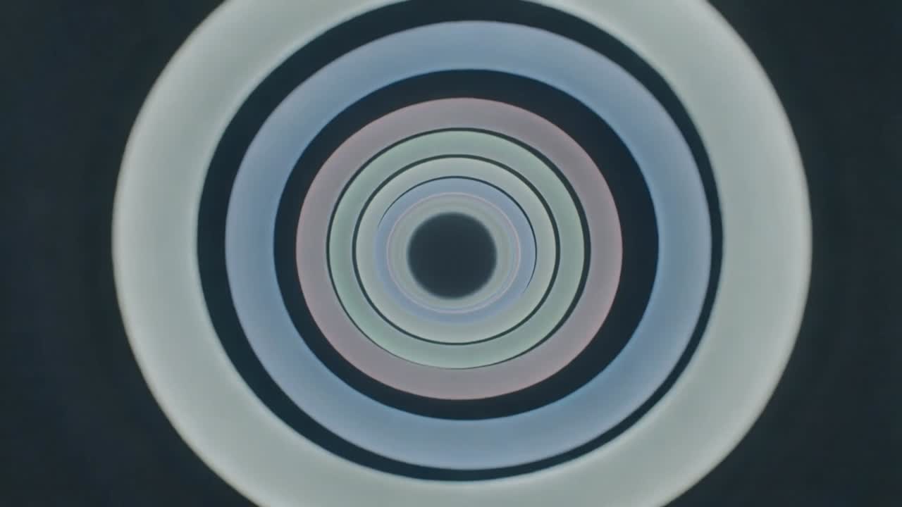 Concentric rings on play, pulsing and rotating, showing dark core and thin gaps for motion design