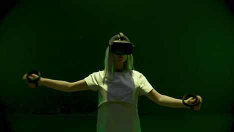 neon girl playing vr game in headset closeup. beautiful millennial using console