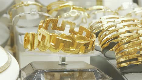 Shiny-gold-bracelets-rotate-on-display-in-shopfront-window