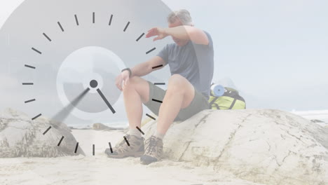 caucasian senior man hiking in countryside, taking a rest, over fast moving clock face