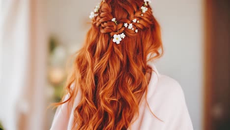 woman with red curly hair and floral updo