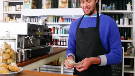 Waiter-counting-cash-at-counter