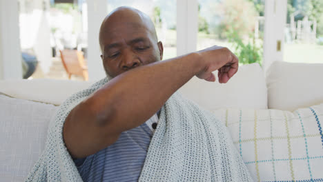 senior african american man sneezing