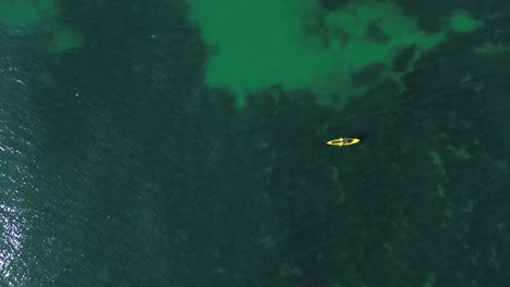 aerial view of kayak fishing at seascape, trolling fishing drone view