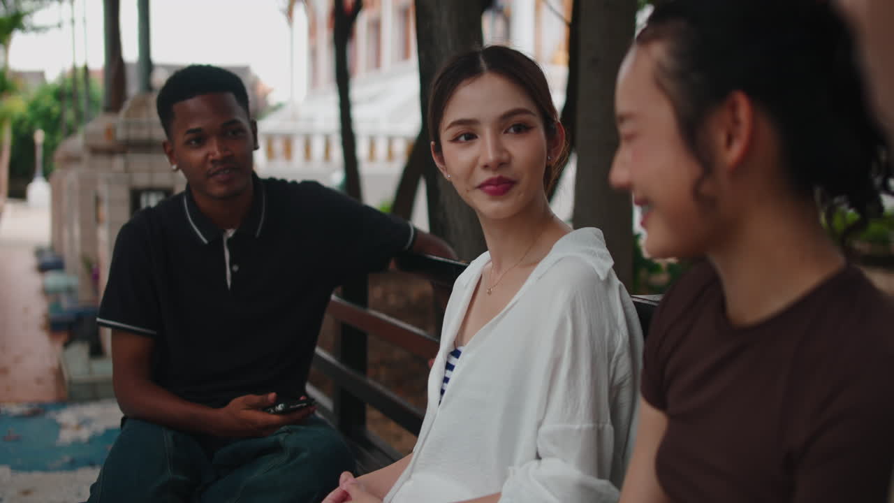 Group of people talking and smiling outdoors