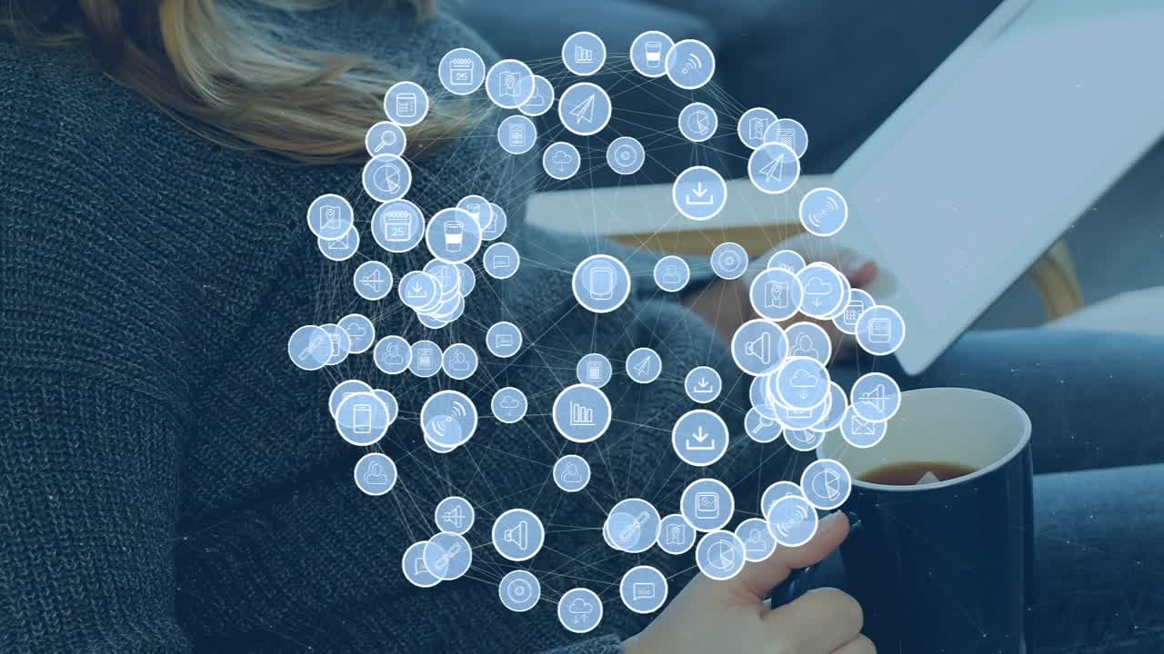 Animation of globe made of icons over caucasian woman with notes and coffee sitting on sofa