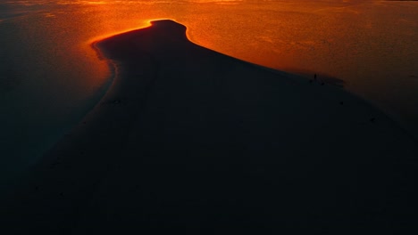 flaming orange sunset shining on an exotic beach