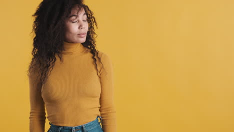 African-american-smiling-woman-over-orange-background.