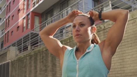 Sporty-Caucasian-woman-fixing-her-ponytail-outdoor