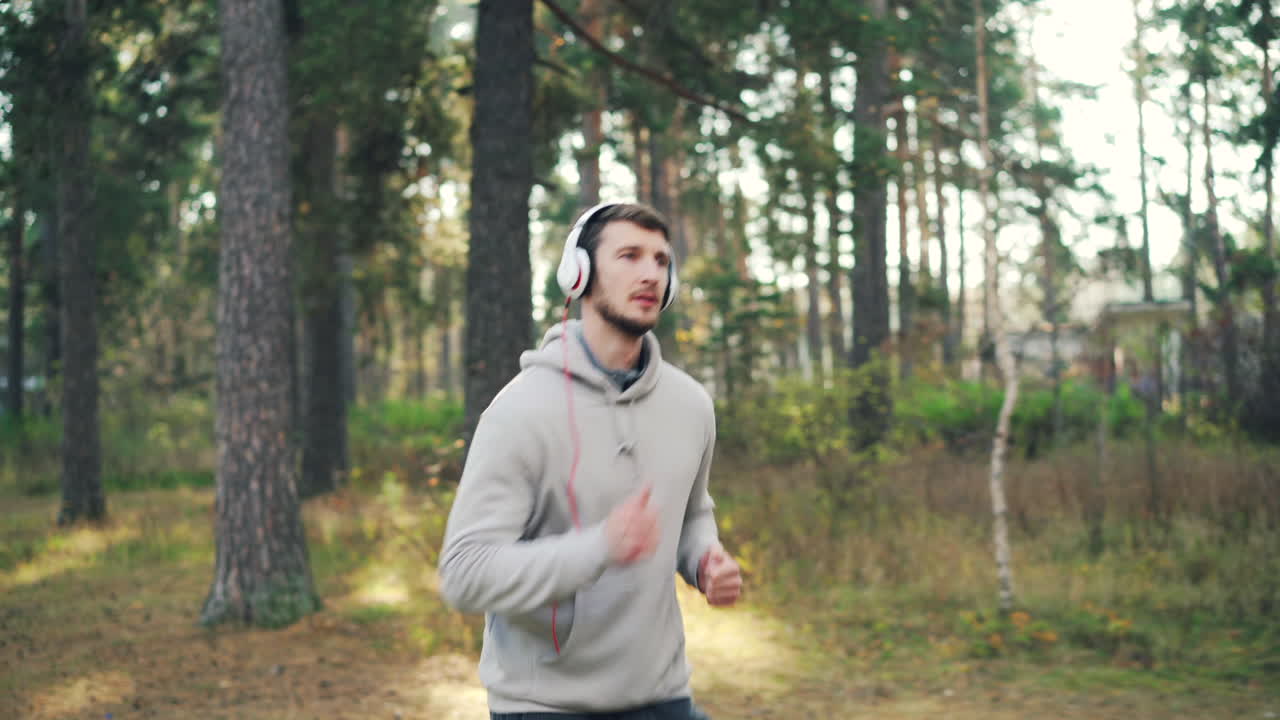 Man Running in a Forest with Headphones