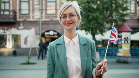 woman holding british flag in the city