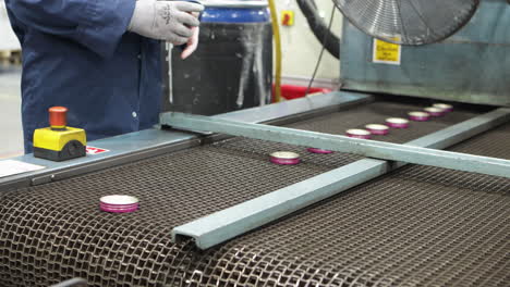 cap produce conveyor line inspected by worker, static view