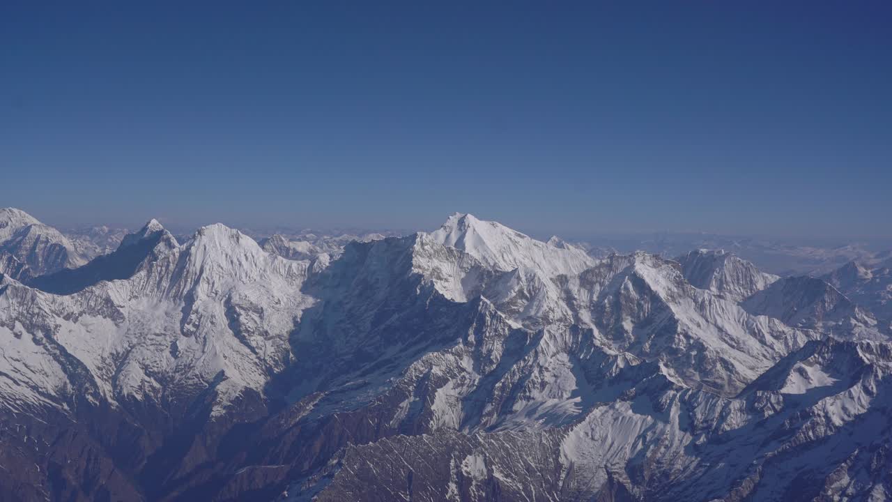 Panoramic Himalayan landscape in Nepal viewed from a mountain flight, capturing rugged peaks and highland scenery