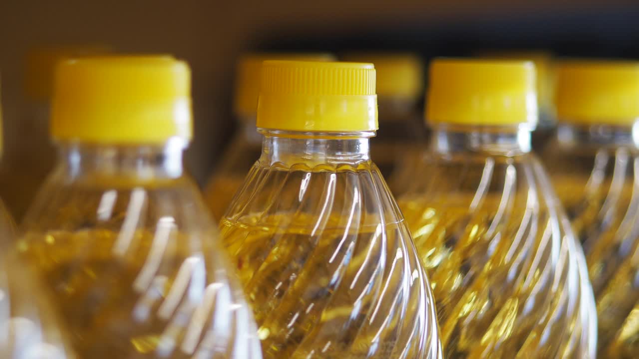 Rows of Oil Bottles with Yellow Caps