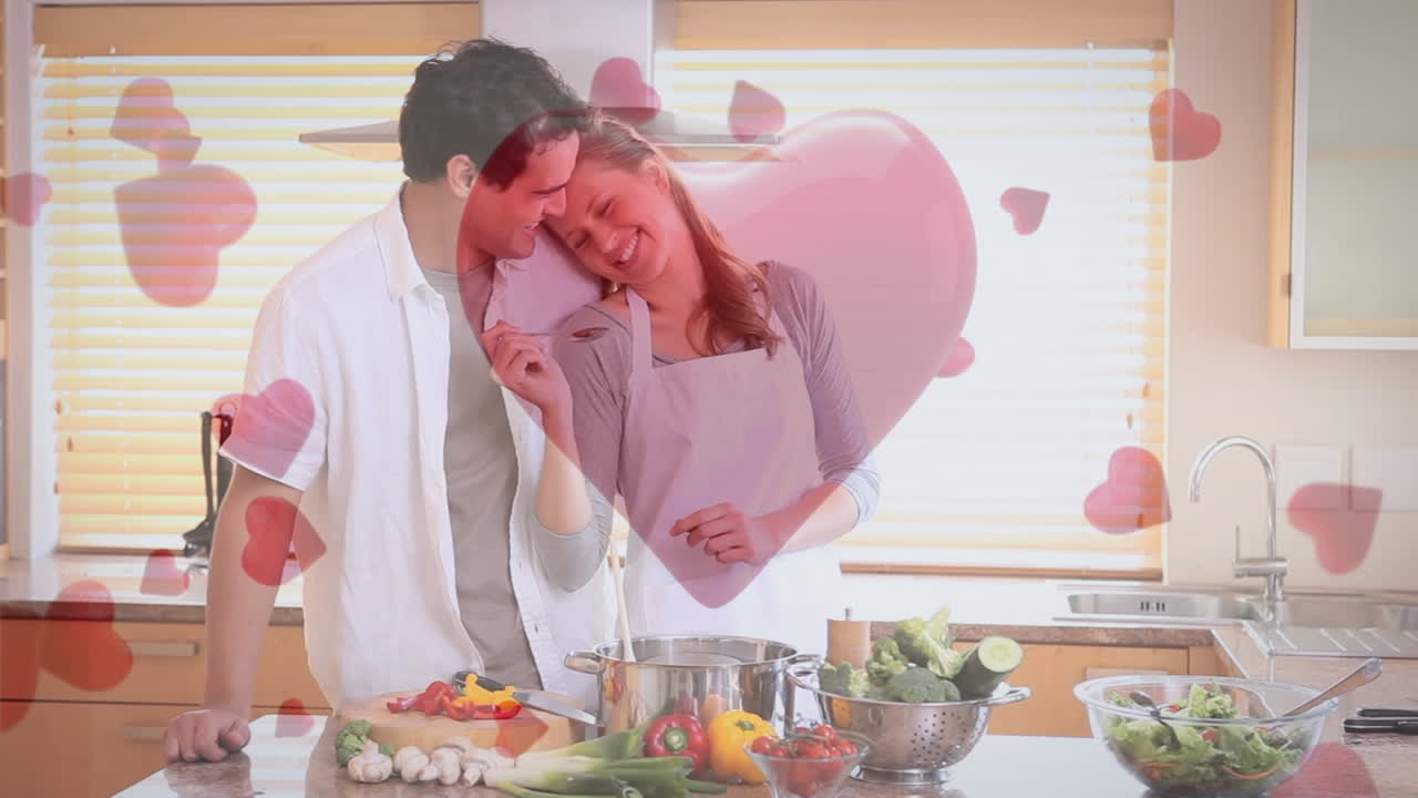 pareja divirtiéndose y cocinando en casa con corazones digitales