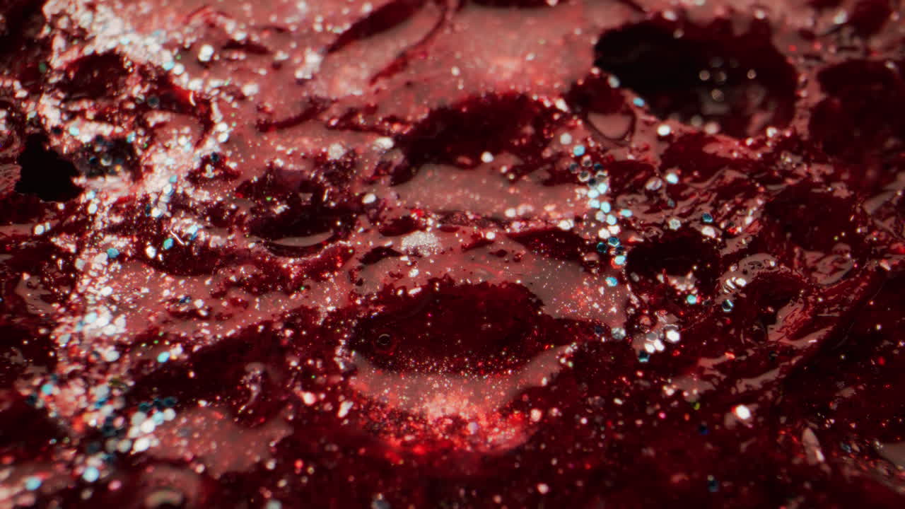 Close-up view of red slime with glitter