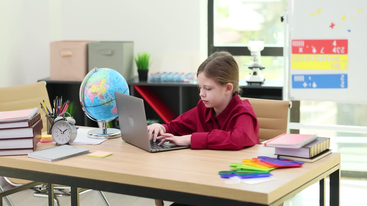 Girl studying with laptop at desk
