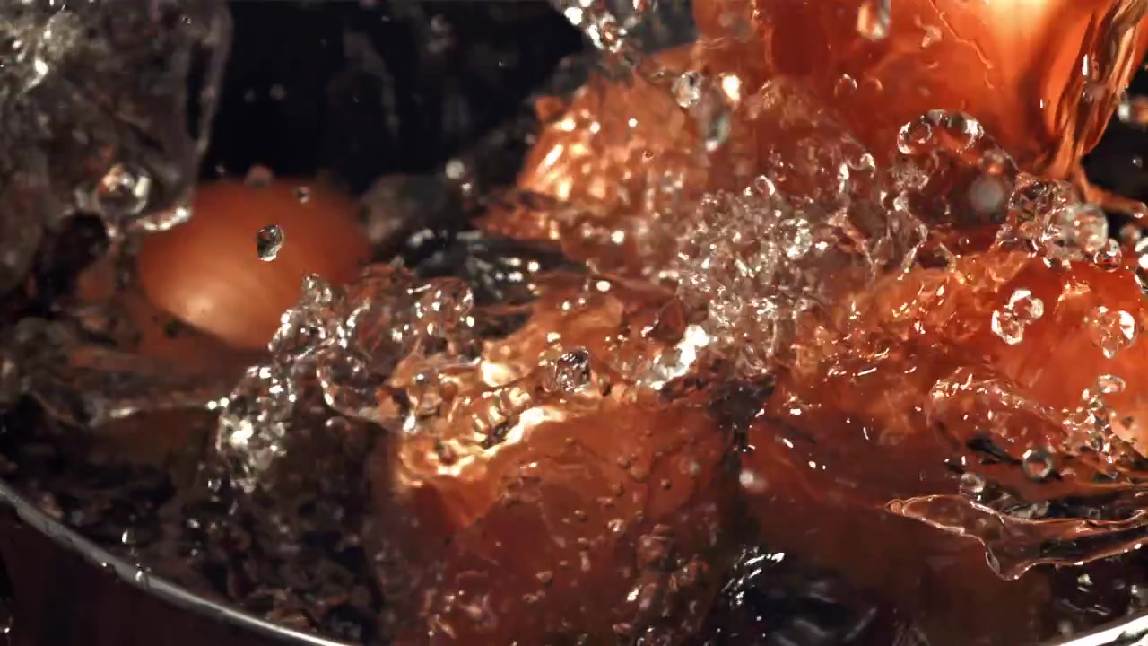 Onion Dropping into Water with Splashes in Slow Motion