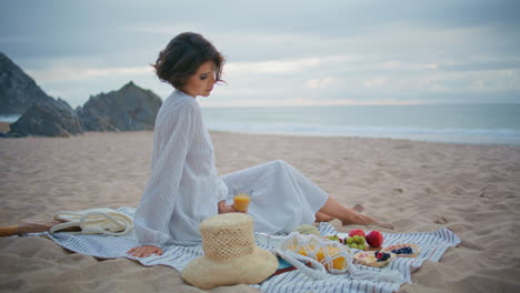 romantic lady resting ocean coast in summer. attractive woman enjoy beach picnic