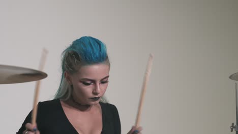 caucasian girl with a deep neckline plays the drums