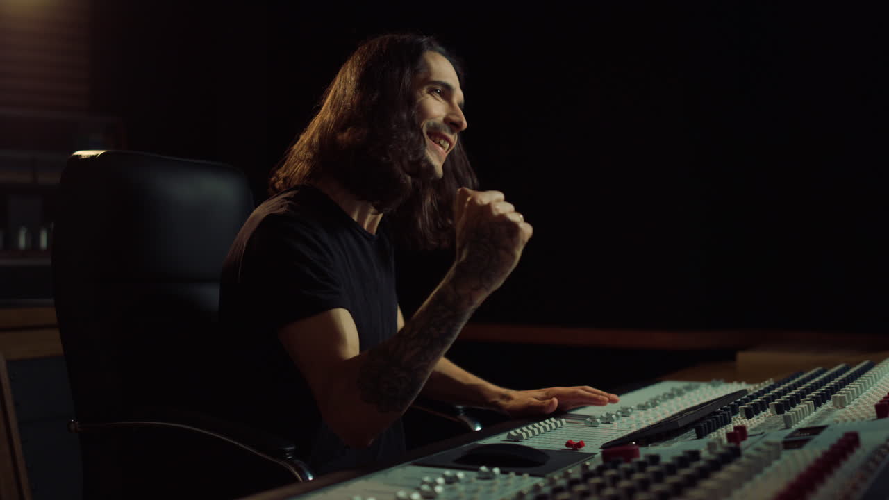 Joyful man gesticulating in music studio. Happy guy listening to music indoor.