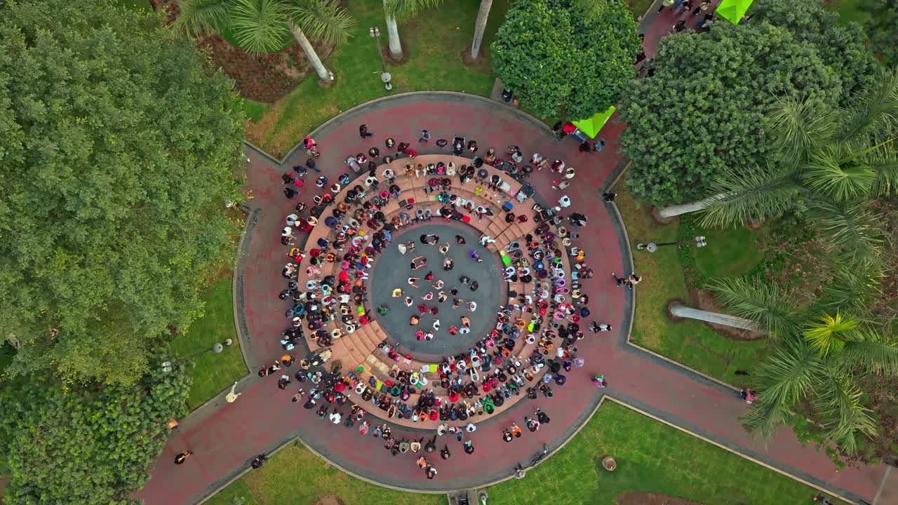 Aerial view of joyful dancers in Miraflores' Kennedy Park, Lima
