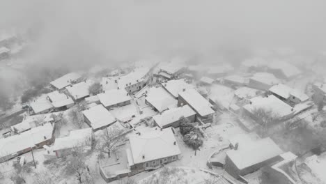 aerial footage over snowy mountain, traditional village in greece 10