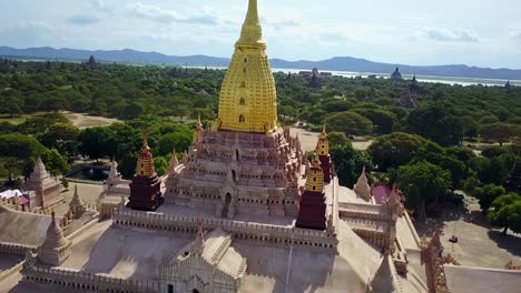 a dynamic aerial push-in shot focusing on the sertock of the white temple in myanmar, showcasing intricate details of its architecture and serene surroundings. ideal for cultural and travel content.