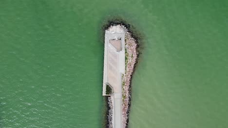 aerial view of a pier with waves of the lake