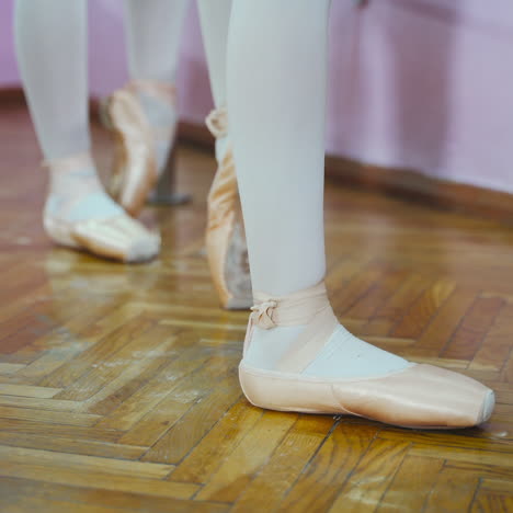 close-up of ballerina feet in pointe shoes. woman's feet in pointe shoes. dancing ballet elements.