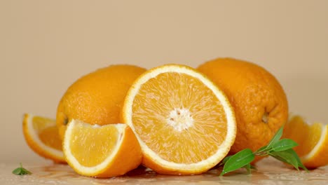 sliced and whole oranges slowly rotate.