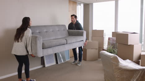 young-couple-moving-house-new-home-owners-smiling-enjoying-successful-move-hugging-in-apartment