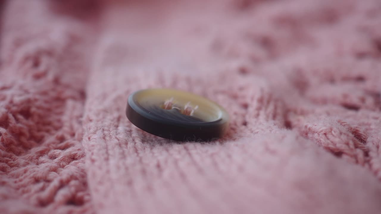 Close-up of a button on a knitted fabric