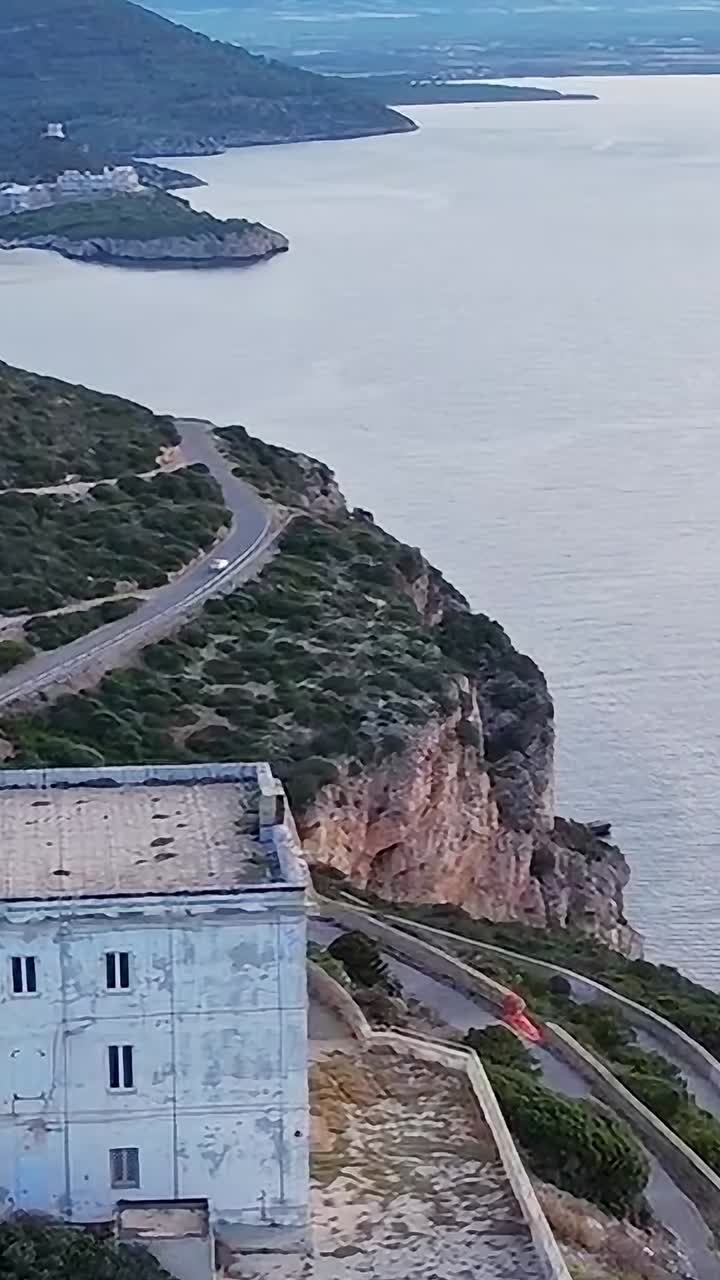 Lighthouse on the coast of Sardinia with sea views and rocky landscape