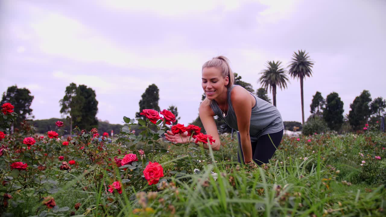 Gorgeous Woman Connecting With  Nature In Rose Gardens - Wide Shot