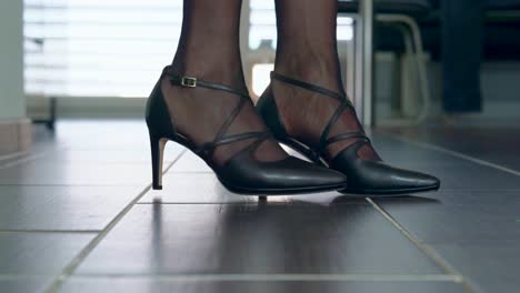 woman presents her sexy high heels in the catwalk silently in the apartment filmed from the floor closeup