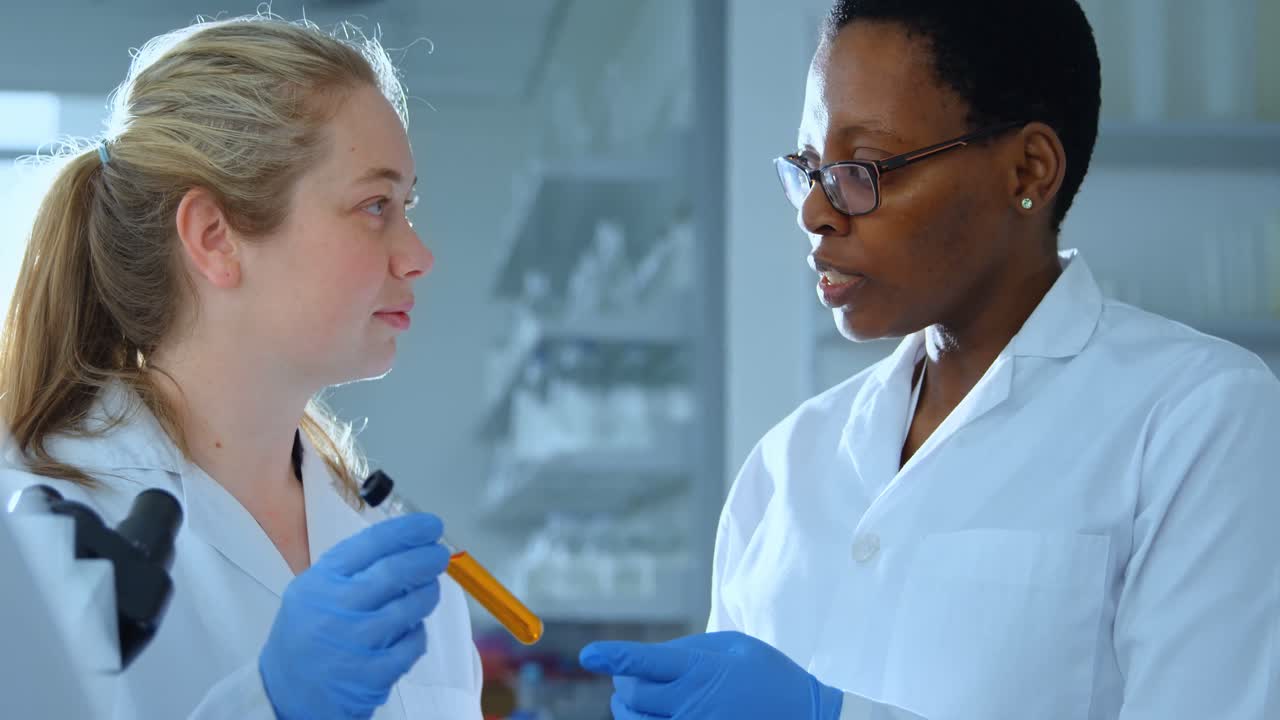 Female scientists discussing over chemical 4k