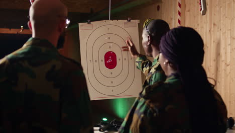 military officer instructing soldiers on how to hit bullseye in firing range