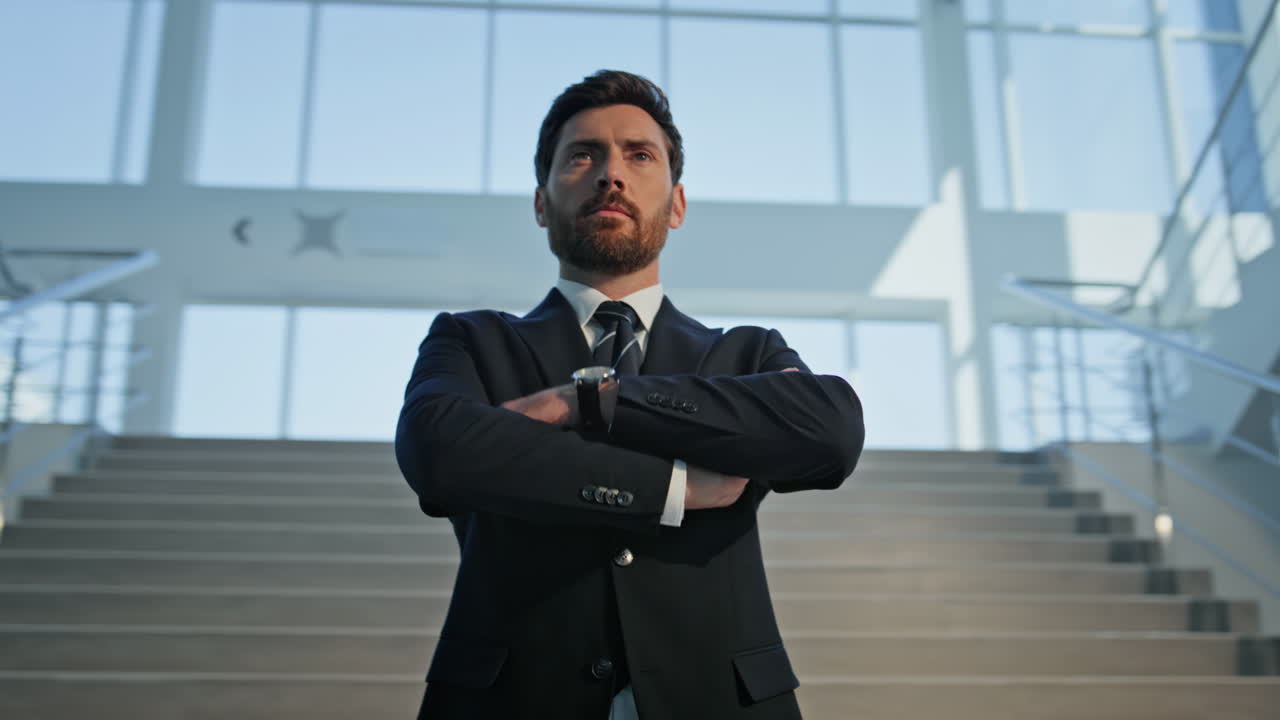 Business owner standing stairs office building with confident posture closeup