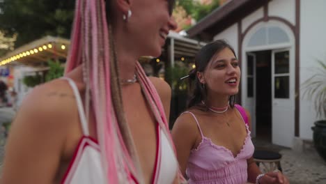 two women with braids standing in front of a restaurant
