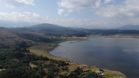 stunning aerial view of a serene lake surrounded by mountains
