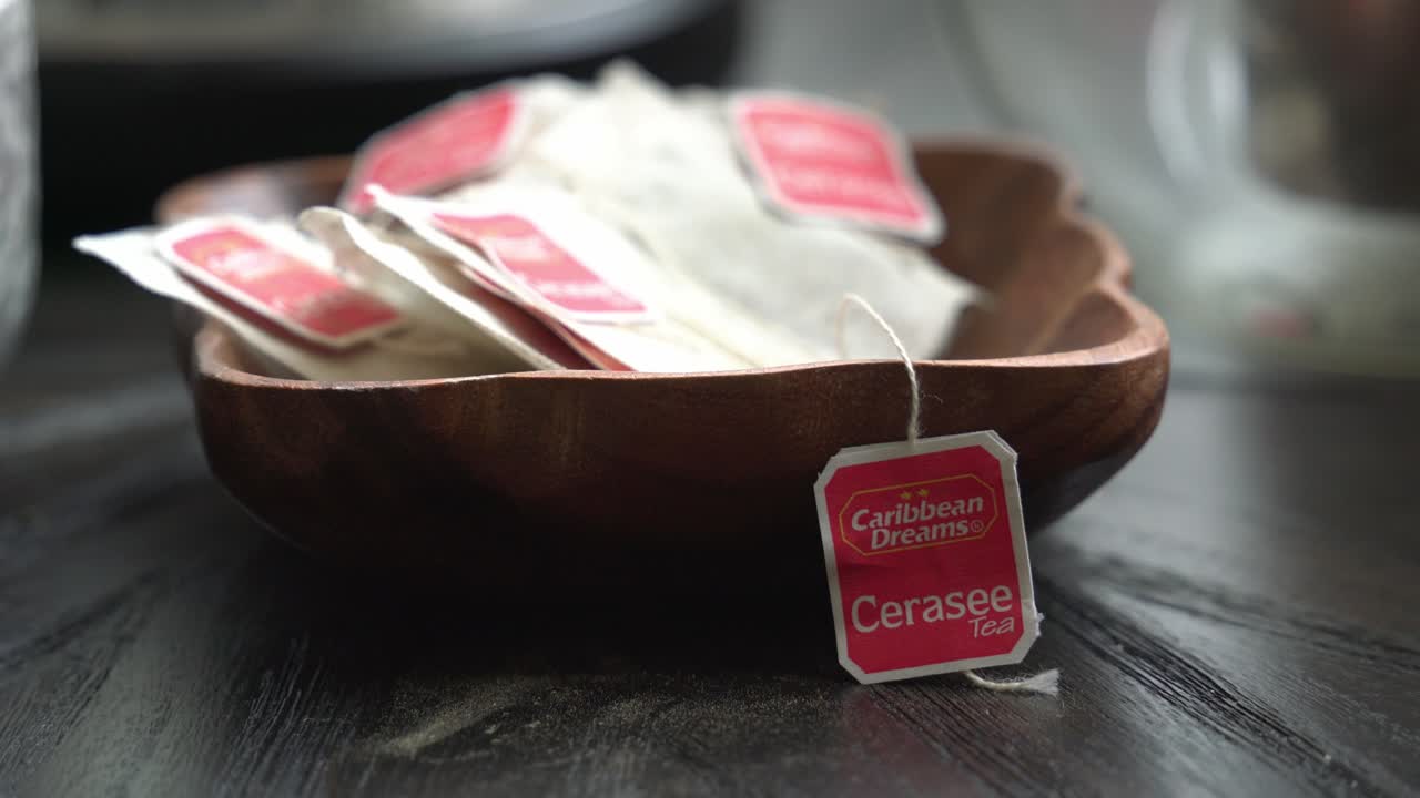Cerasee kerala tea on table bitter melon plant with kerala hanging from vines used to make herbal healthy tea good for weight loss