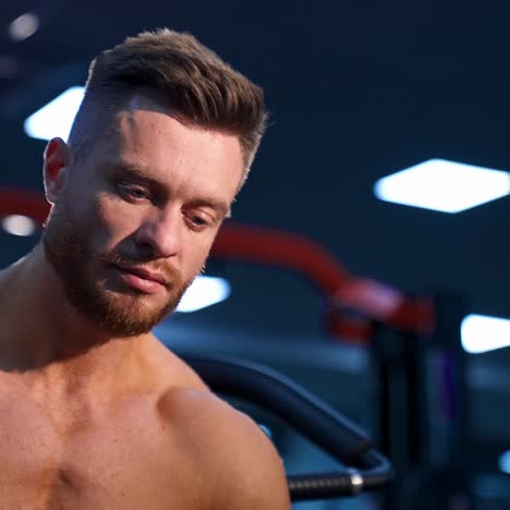 athlete with strong body poses on modern gym background. view from the bottom
