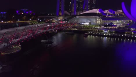 drone shot of traffic on a bridge near river at night