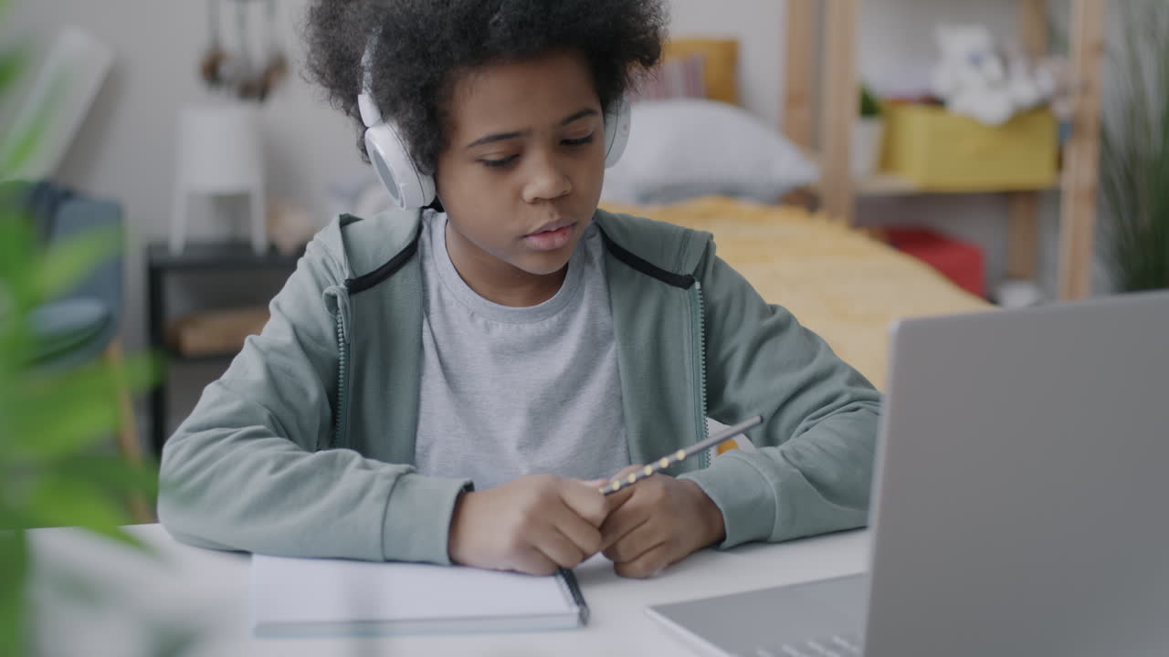 Child Doing Homework on Laptop