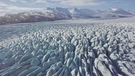 aerial: close up of largest glacier in europe vatnajokull. beautiful glaciers flow through the mountains in iceland. concept of global warming skaftafell glacier, vatnajokull national park in iceland.